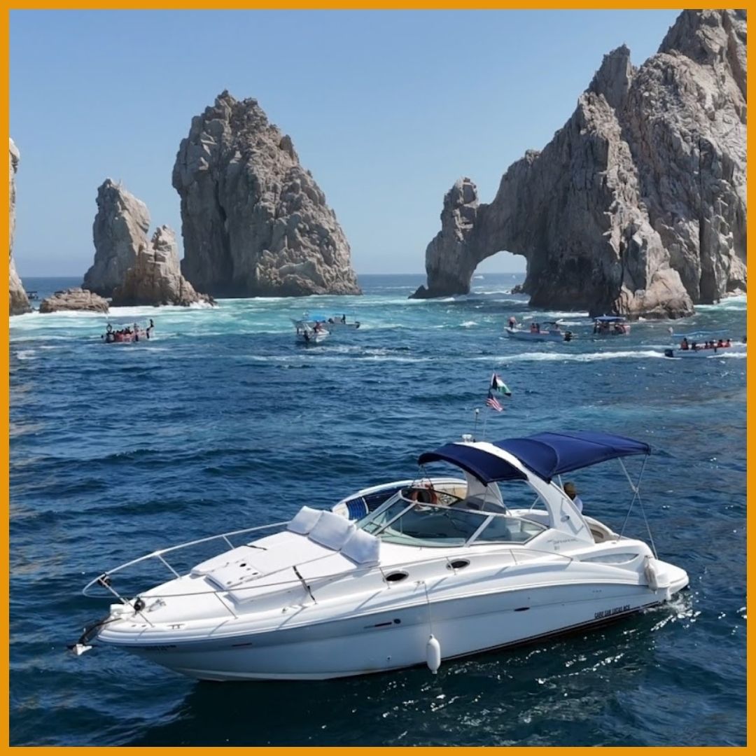 yacht in waters in front of arch